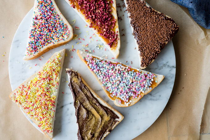 6 different fairy bread recipes - sprinkles on toast cut into triangles overhead shot | The Worktop