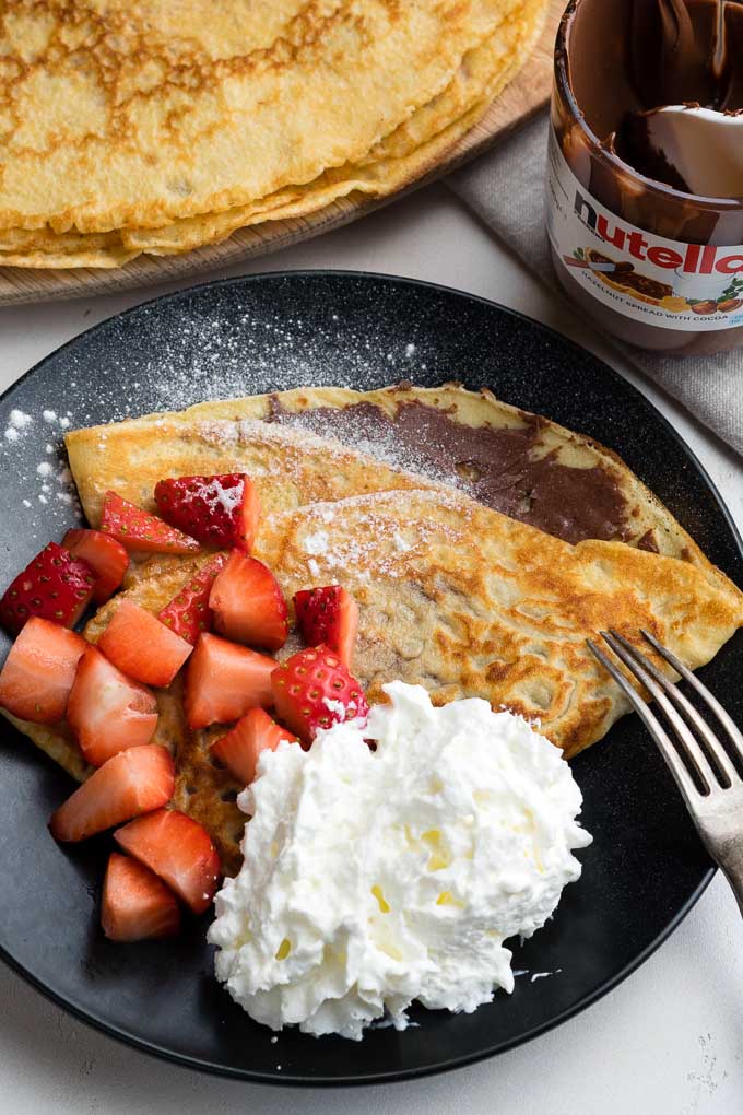 Strawberry Nutella Crepes - plated with whipped cream | The Worktop
