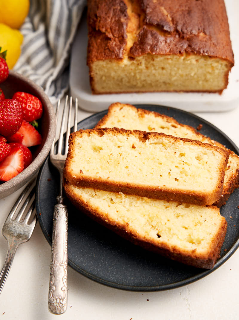 Lemon Sour Cream Pound Cake - Sliced on a plate with strawberries | The Worktop
