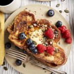 Challah Bread French Toast Recipe - close up shot with butter, berries and maple syrup | The Worktop