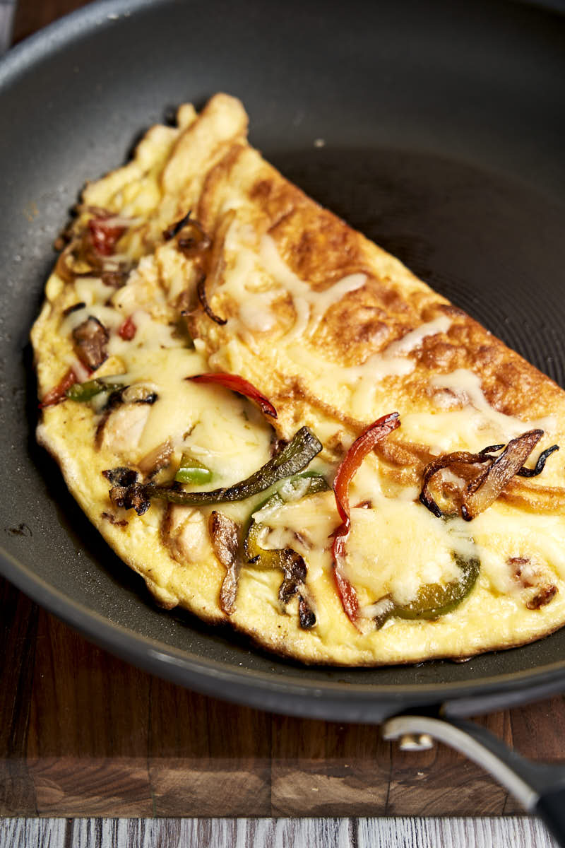 Chicken Fajita Omelette Recipe - in skillet, folded and with cheese and peppers | The Worktop