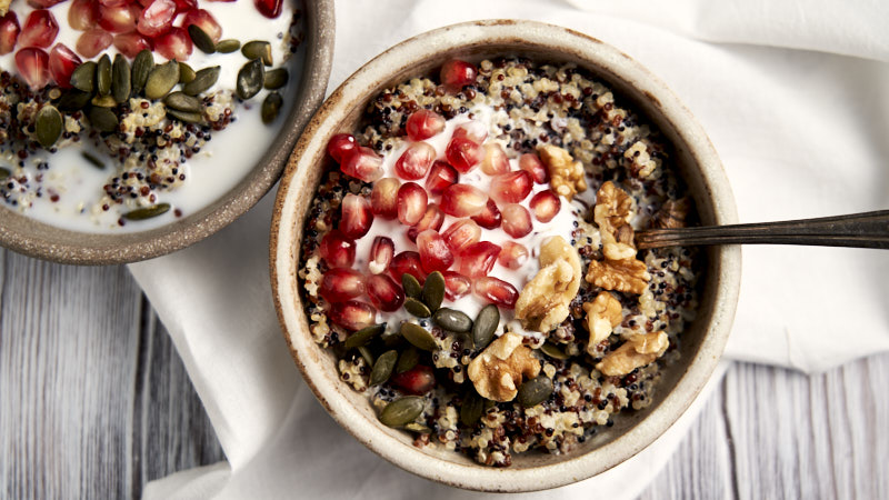 Quinoa Porridge for Breakfast - overhead with walnuts, pumpkin seeds and yogurt | The Worktop