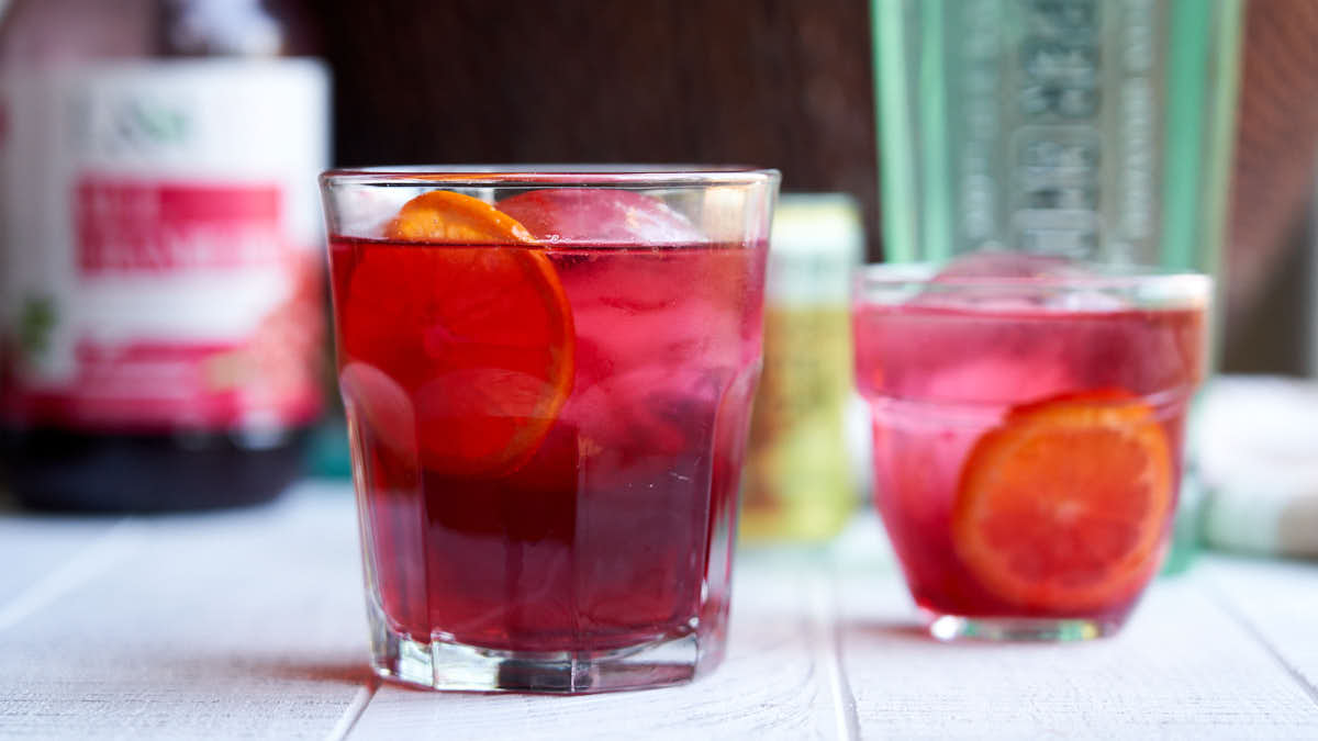 Cranberry Gin Cocktail - 2 glasses with round ice cubes for a Christmas morning cocktail