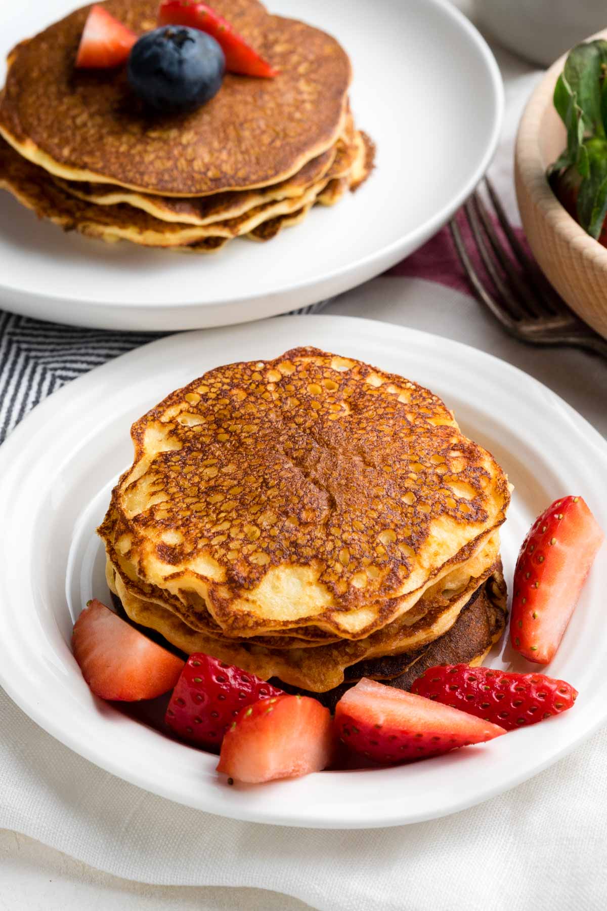 Pancakes made with cottage cheese stacked with strawberries. GF recipe | The Worktop