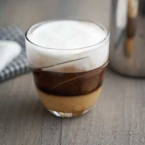 Cafe bombon - clear cup with condensed milk, espresso and froth on top