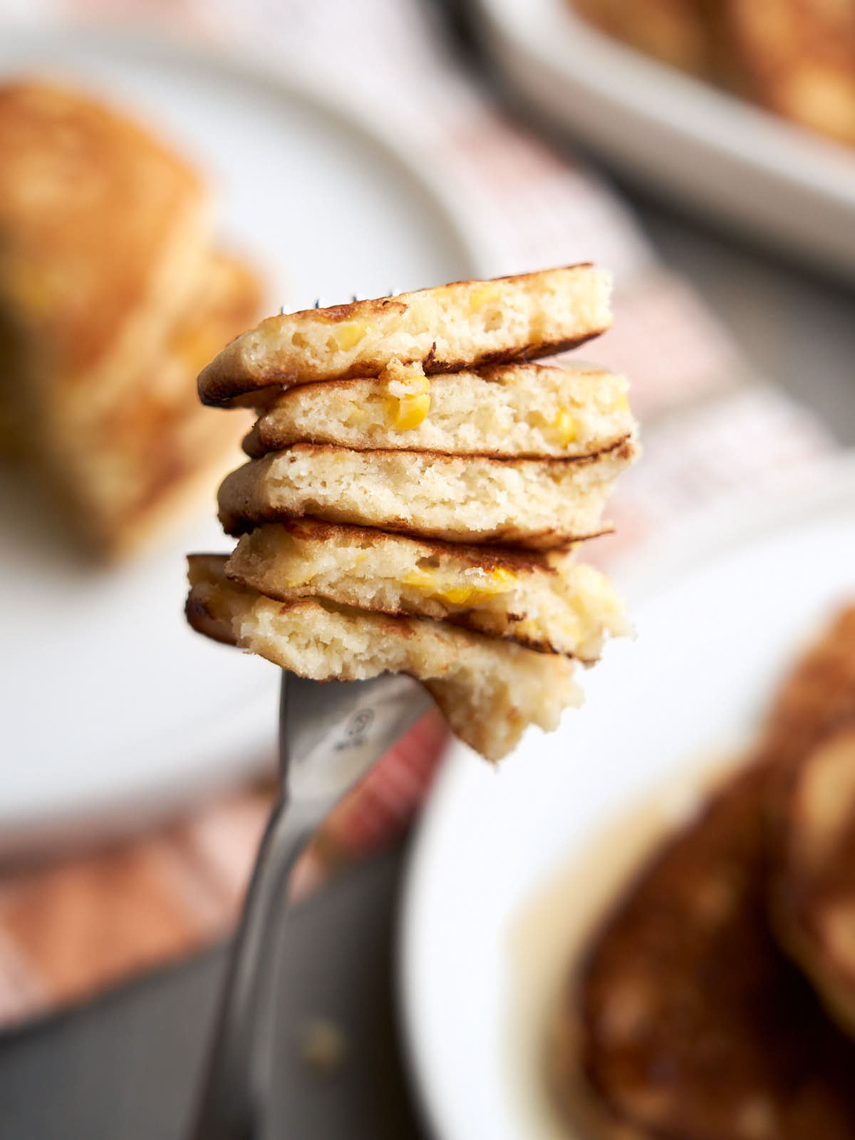 Canned cream corn pancakes stacked on a fork